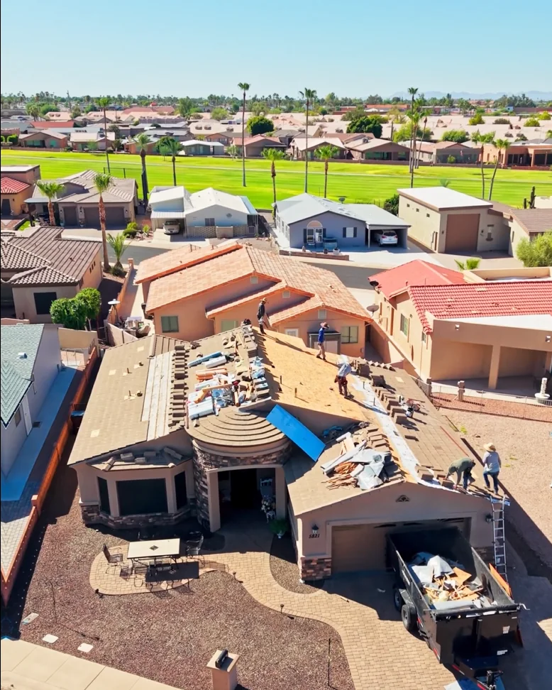 Restoration X crew replacing a tile roof, old tile pulled and decking exposed